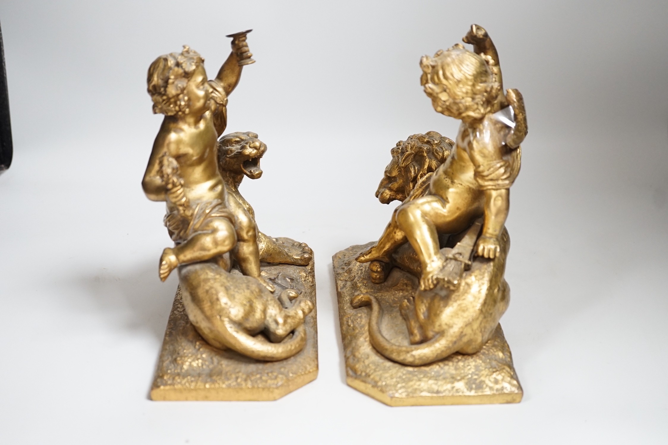 A pair of 19th century gilt metal cherub groups, 20cm tall